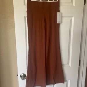 Athleta Salutation Stash flare pant in rust.